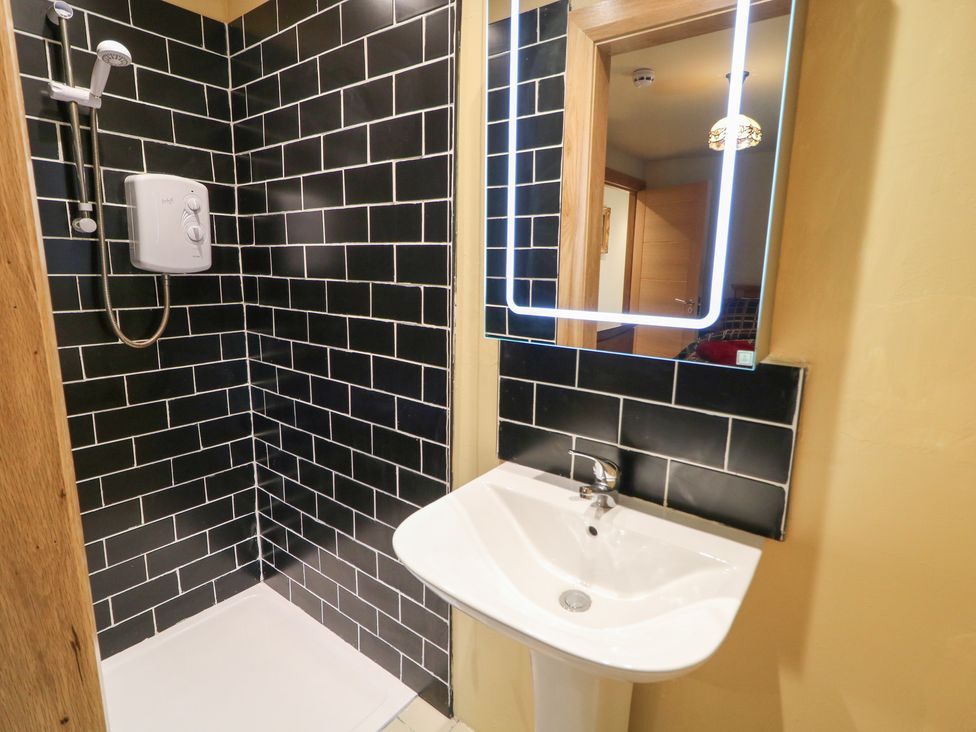 A bathroom with a shower and sink at Crea The Mission Hall near Ballymena