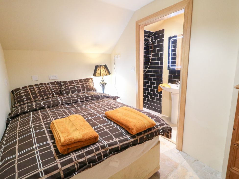 A bedroom with a bed and towels on top at Crea The Mission Hall near Ballymena