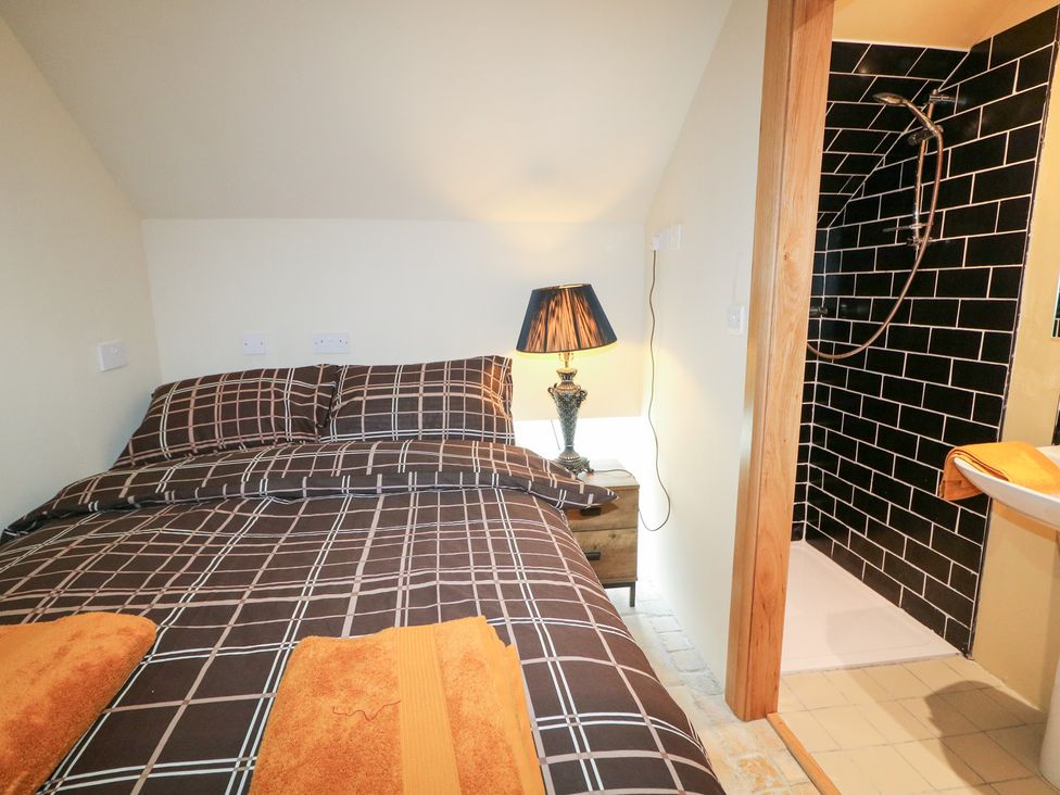 A bedroom with a bed and shower area at Crea The Mission Hall near Ballymena