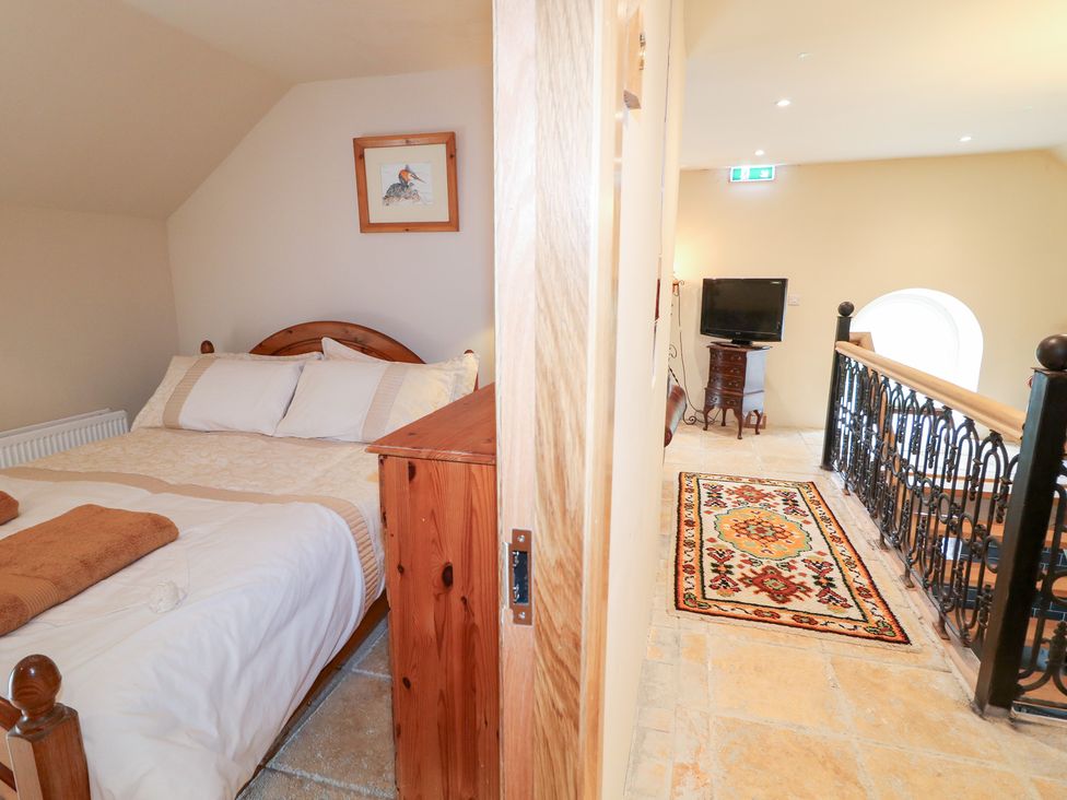 A bedroom with a bed and TV at Crea The Mission Hall near Ballymena