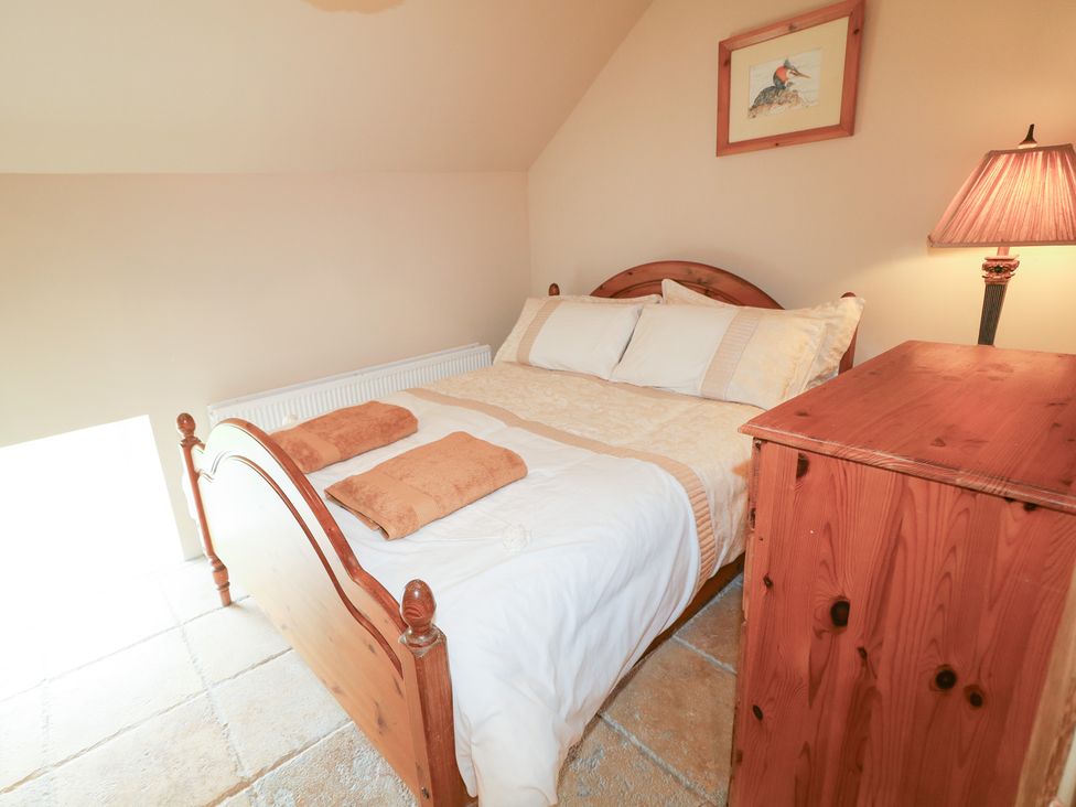 A bedroom with a bed and nightstand at Crea The Mission Hall near Ballymena