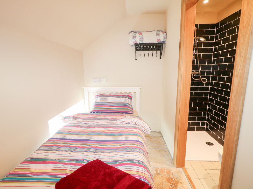 A bedroom with a bed and shower at Crea The Mission Hall near Ballymena
