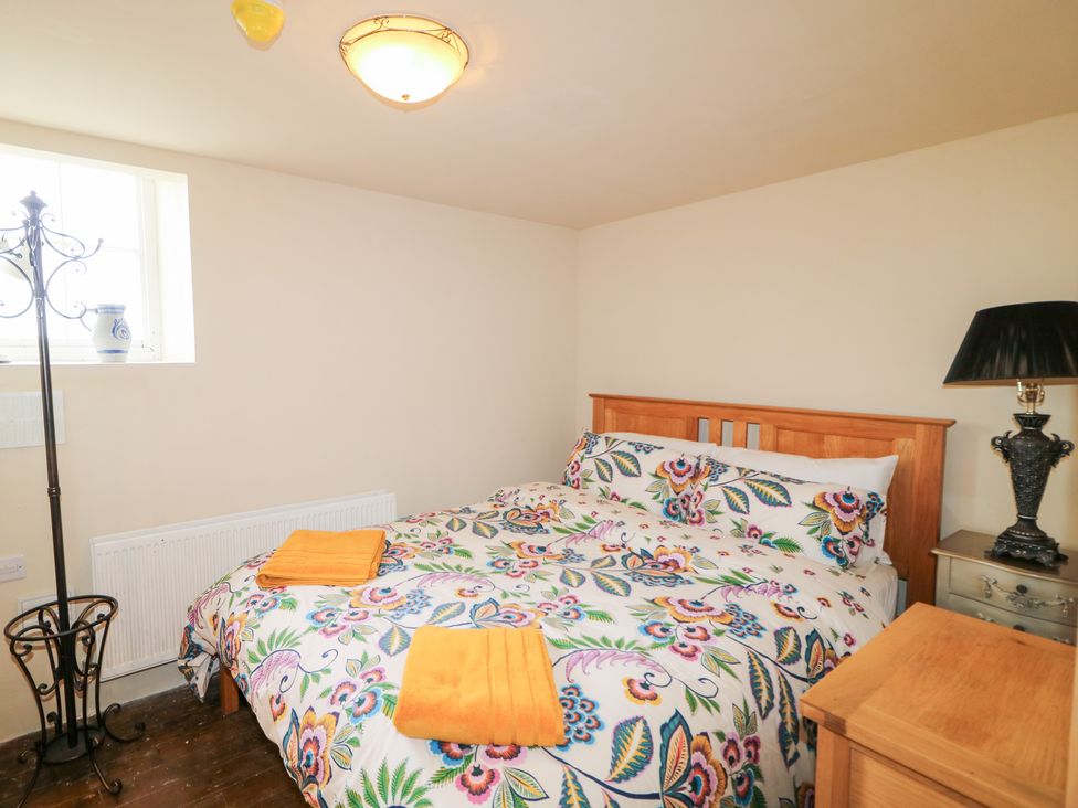 A bedroom with a bed and a lamp at Crea The Mission Hall near Ballymena