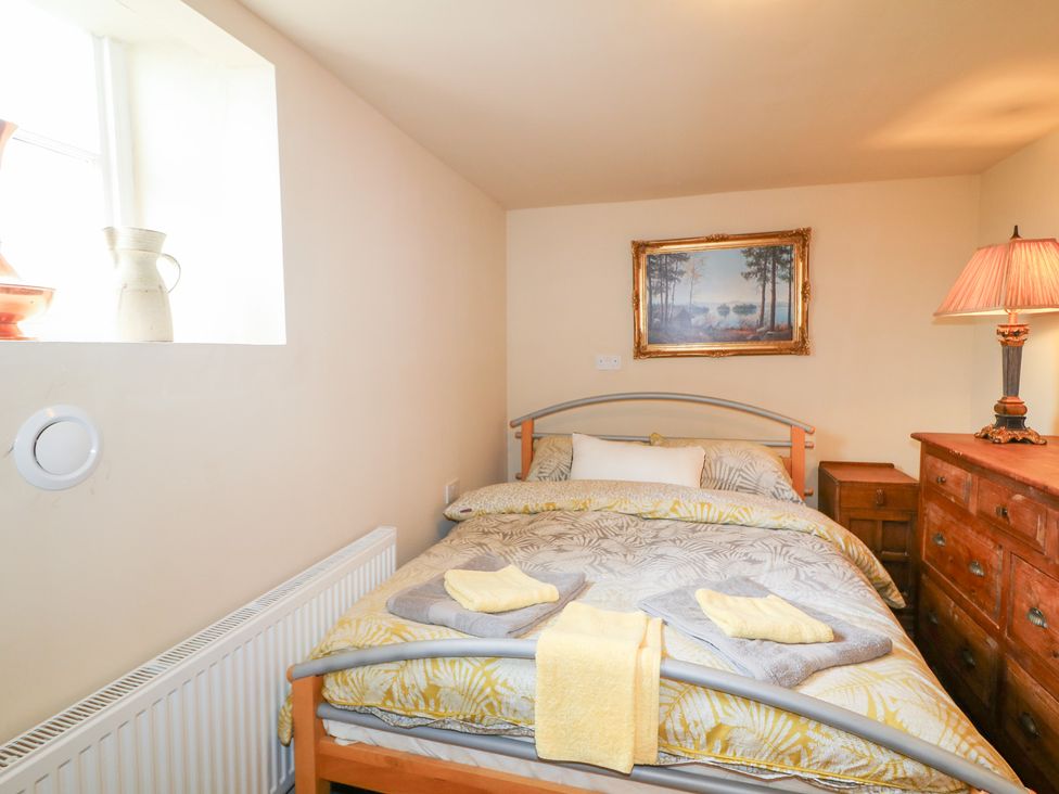 A bedroom with a bed and chest of drawers at Crea The Mission Hall near Ballymena