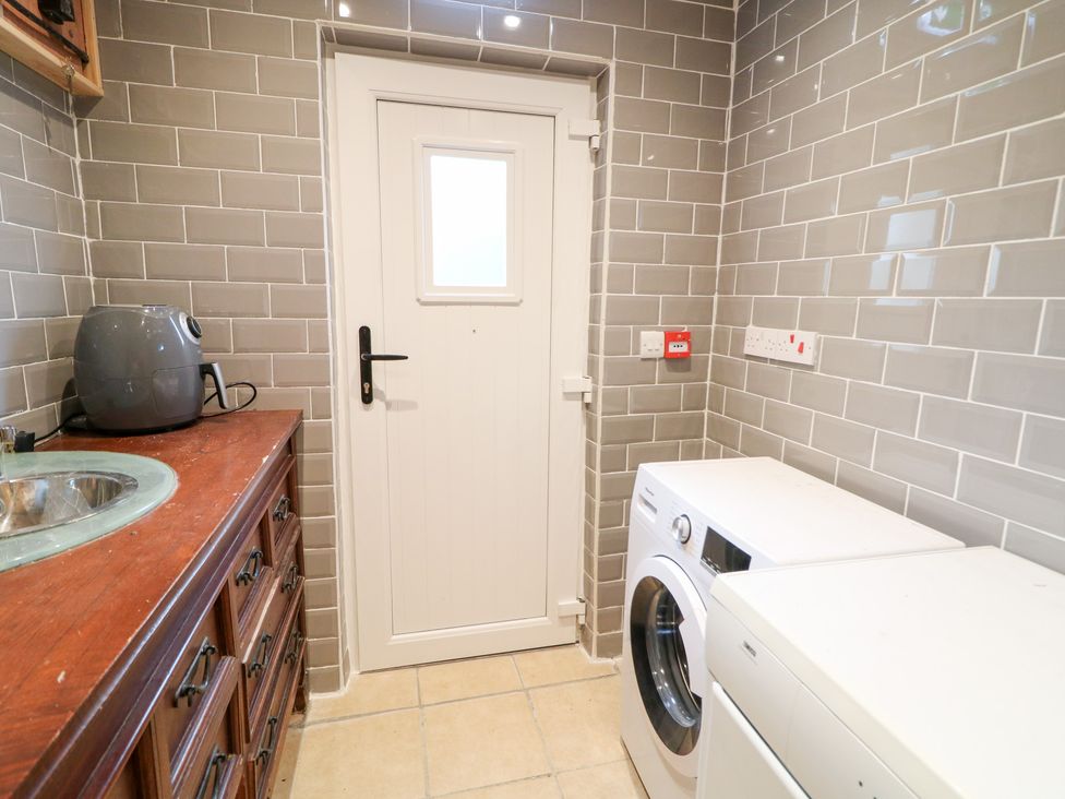 A laundry room with a washing machine and dryer at Crea The Mission Hall near Ballymena