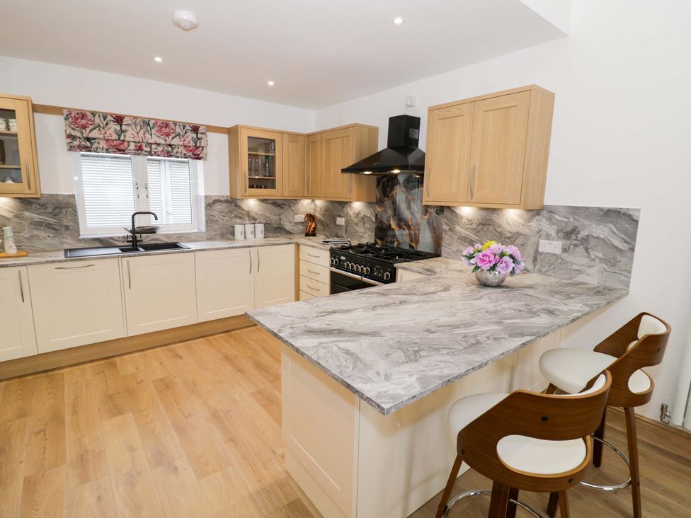 A kitchen with cabinets and a stove at The Barn in Astwood Bank
