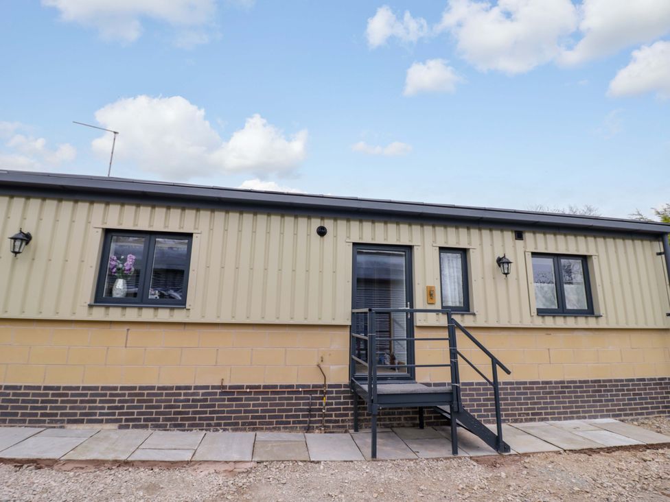 An outdoor view of a residential building with steps at The Barn in Astwood Bank