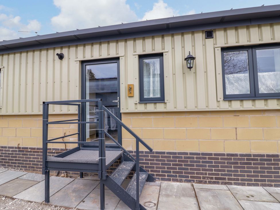 An entrance with steps leading to a door at The Barn in Astwood Bank