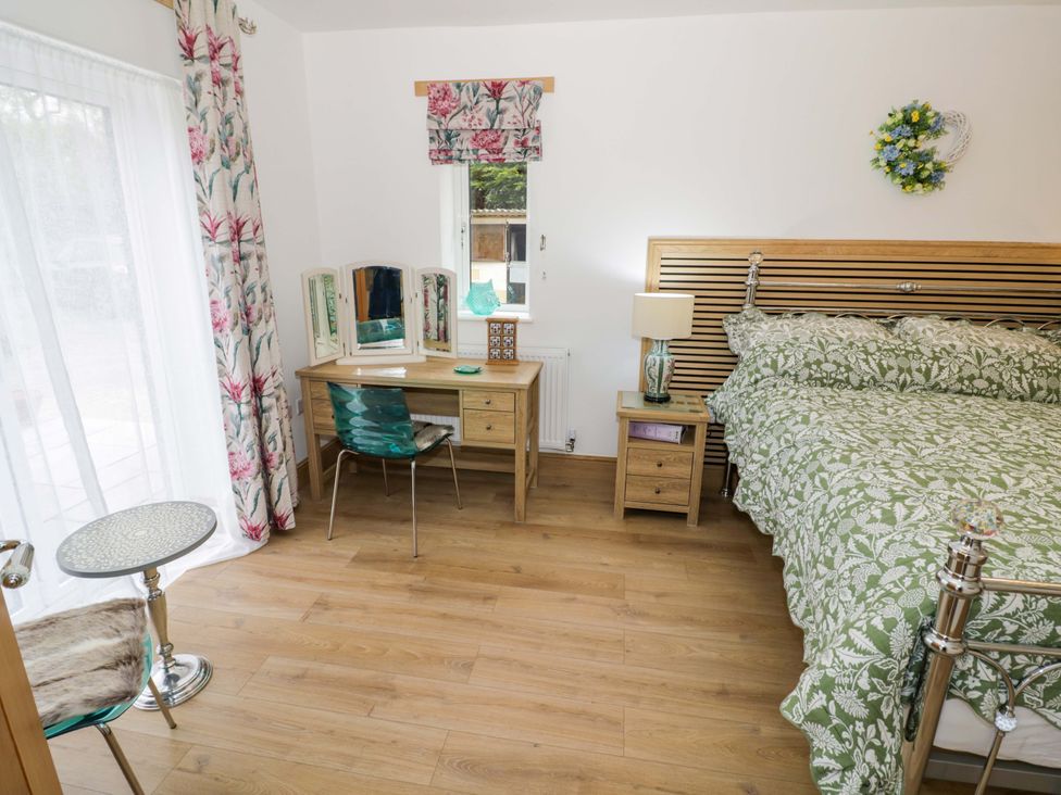 A bedroom with a bed and desk at The Barn in Astwood Bank