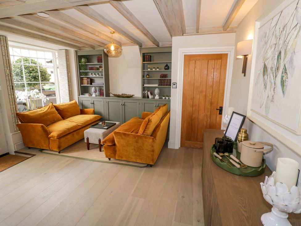 A living room with a sofa and coffee table at Bay House Cottage in Broadway