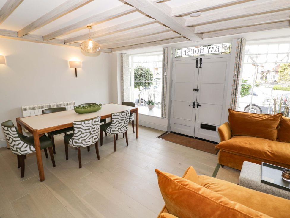A dining room with a table and chairs at Bay House Cottage in Broadway