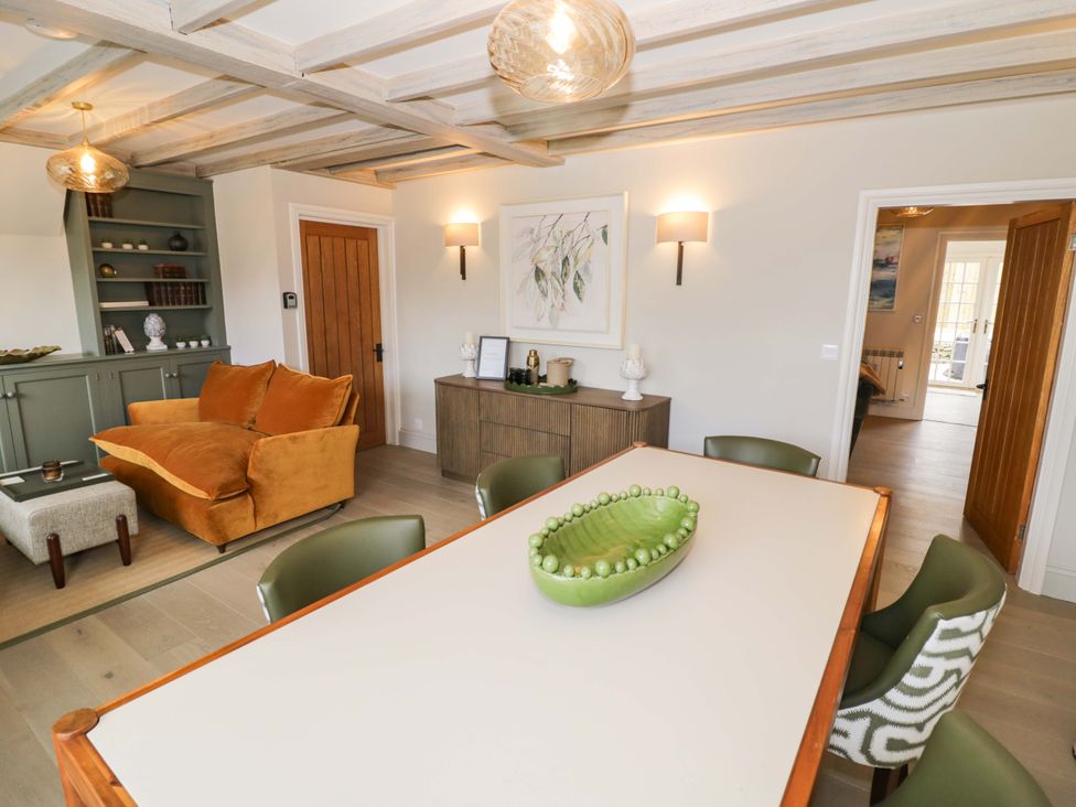 A dining room with a table and chairs at Bay House Cottage in Broadway