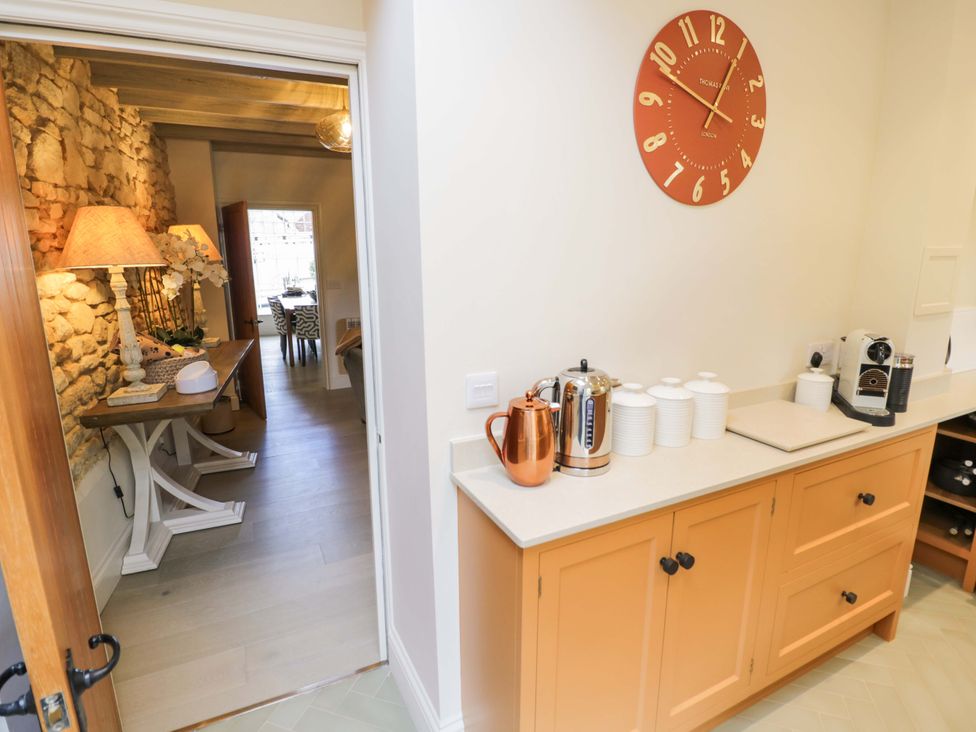 A kitchen with a kettle and coffee maker at Bay House Cottage, Broadway