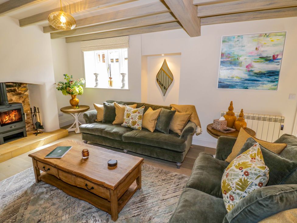 A living room with a sofa and coffee table at Bay House Cottage in Broadway