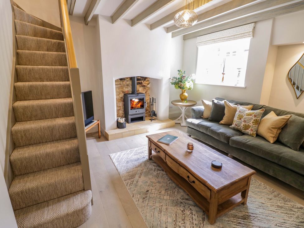 A living room with a sofa and coffee table at Bay House Cottage in Broadway
