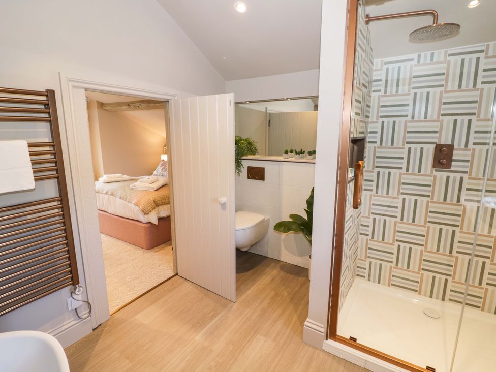 A bathroom with a shower and toilet at Bay House Cottage in Broadway