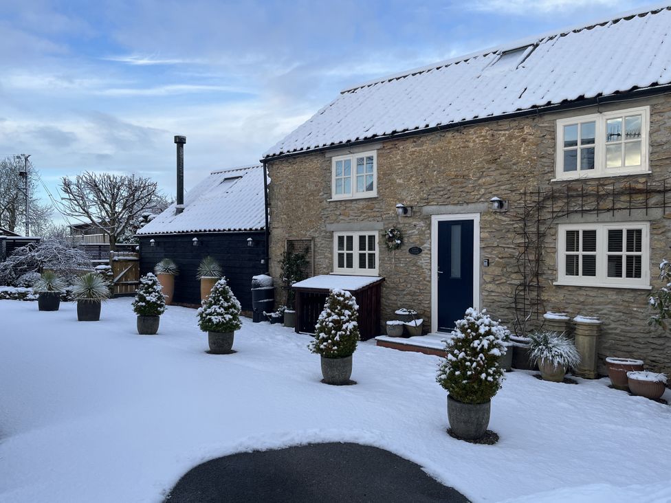 A house with snow and plant pots at A Stones Throw Sawdon near East Ayton