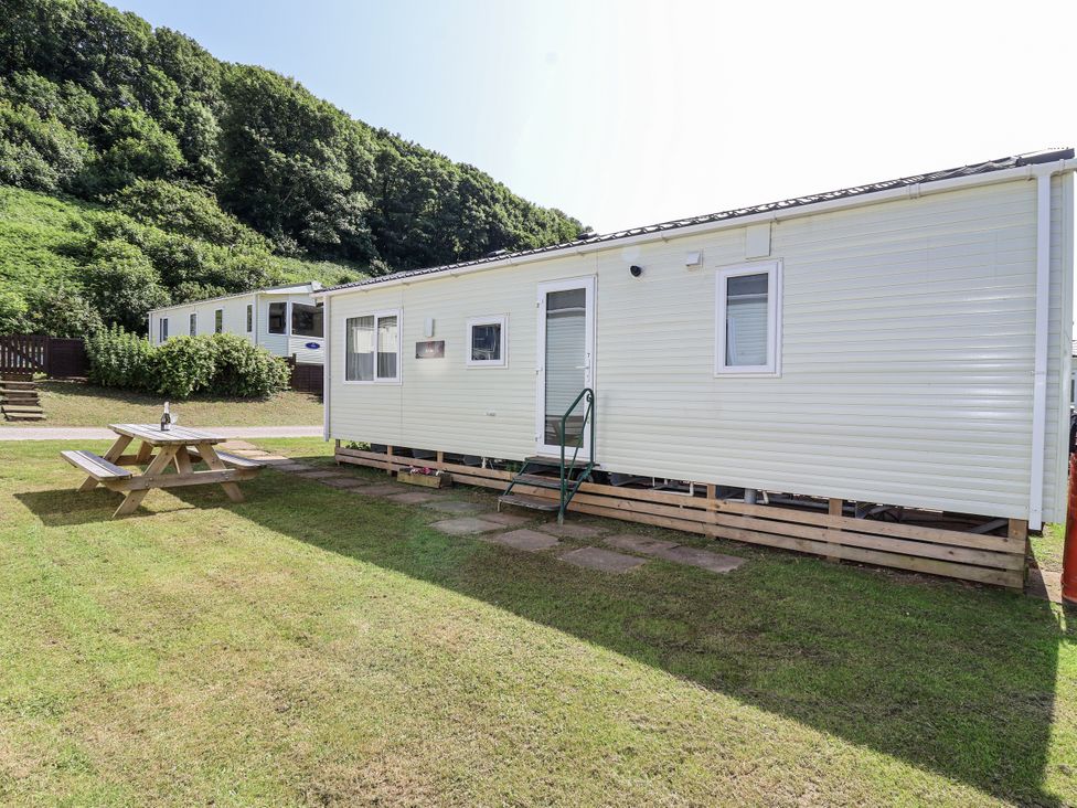 A caravan with a picnic table in front at Caravan 7 Plymouth