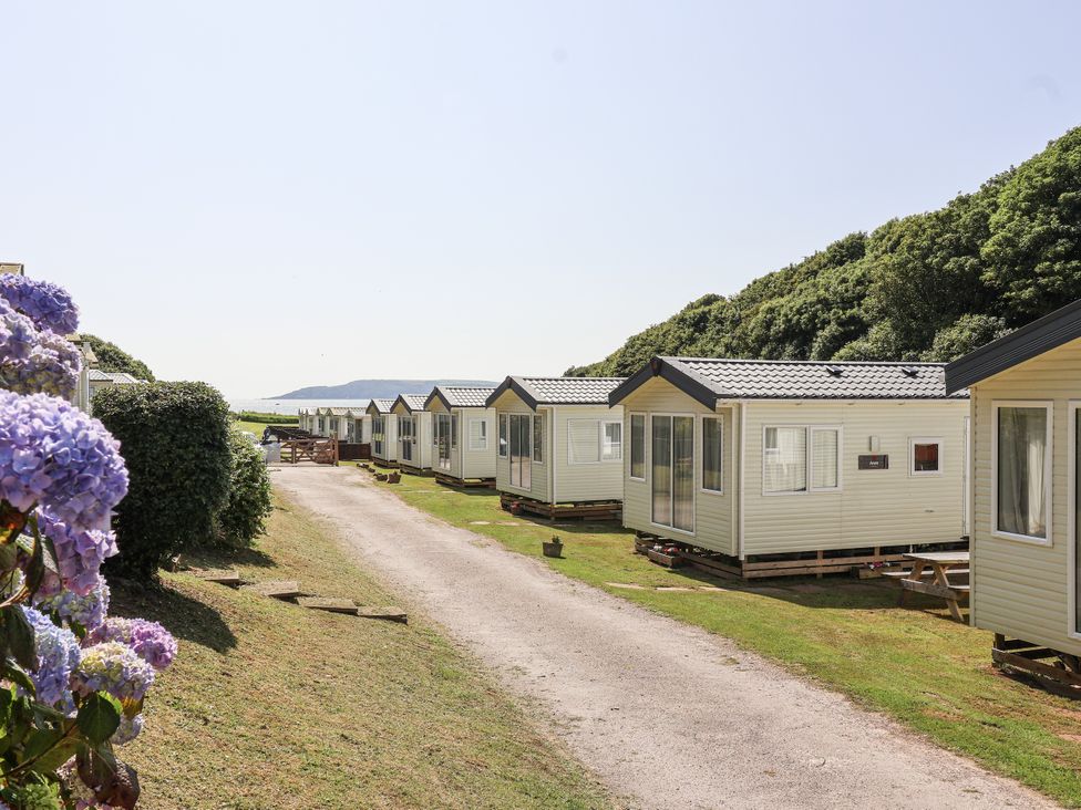 A row of caravans along a path at Caravan 7 in Plymouth