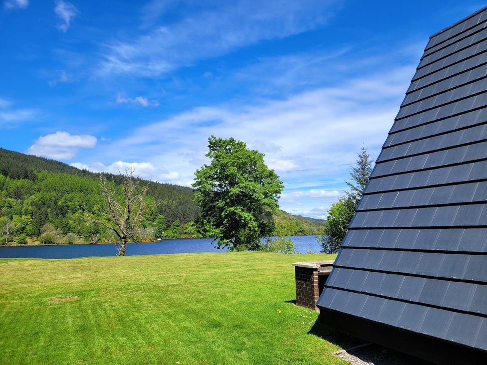A view of a lake with trees and mountains at Lodge 2 - Inglewood Lodge Spean Bridge