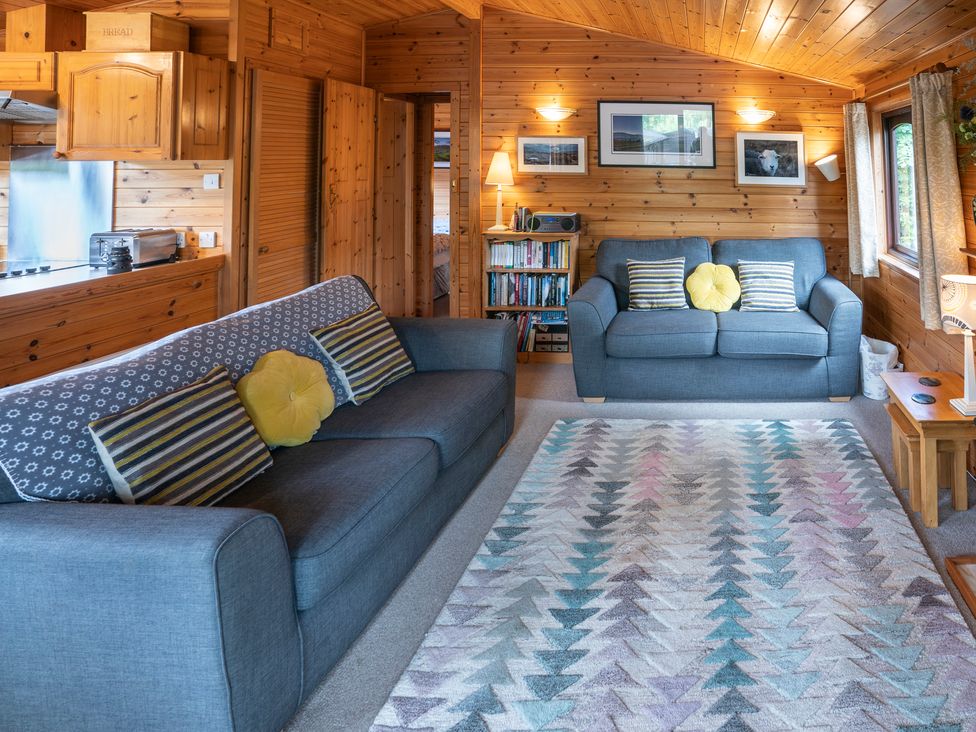 A living room with sofas and a bookshelf at Watendlath in Keswick