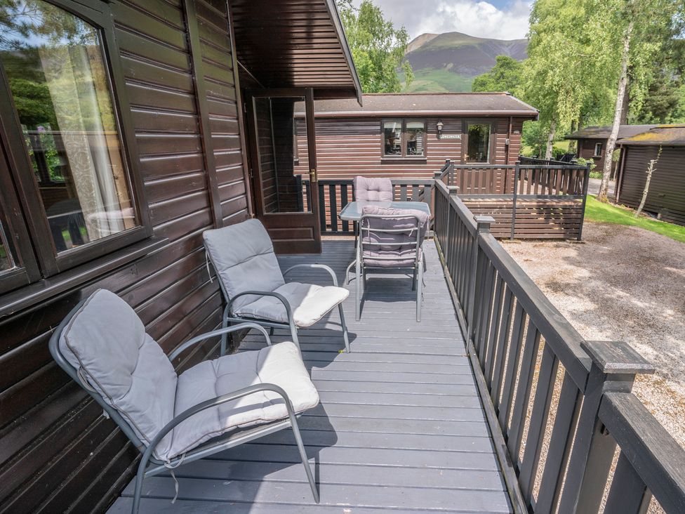 An outdoor deck with chairs and a table at Watendlath, Keswick