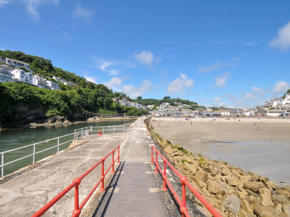 A pathway leading to the beach with buildings in the background at Sea Pinks in Looe