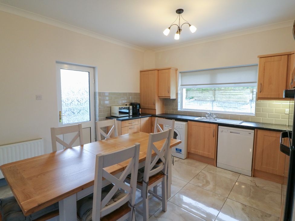 A kitchen with table and chairs at No 1 Lodge Wood, Kenmare, County Kerry