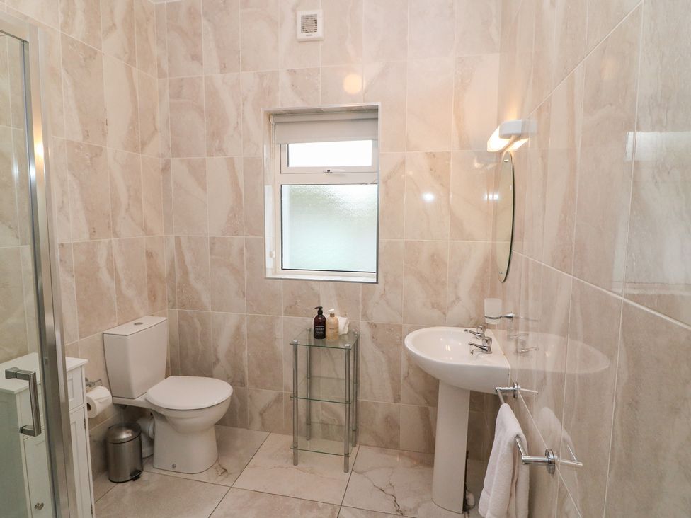 A bathroom with a toilet, sink and shower at No 1 Lodge Wood, Kenmare, County Kerry