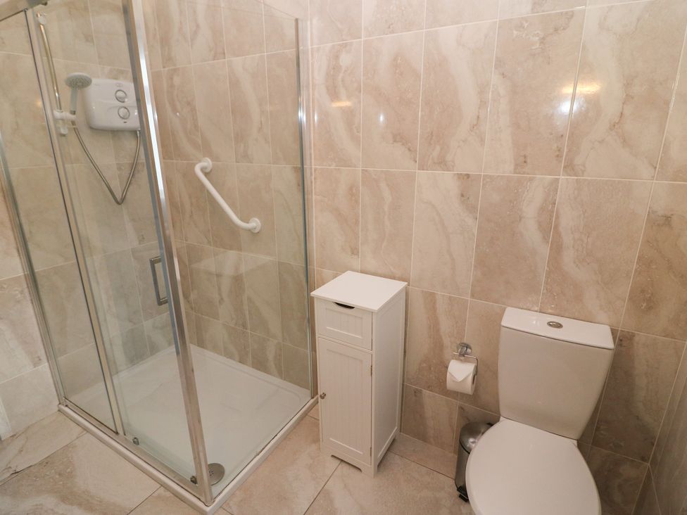 A bathroom with a shower and a toilet at No 1 Lodge Wood Kenmare, County Kerry
