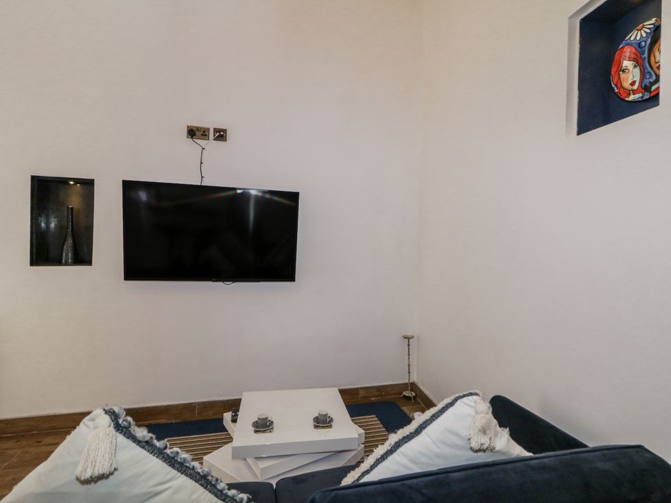 A living room with a television and a coffee table at Derrywilligan 1,2,3 Newry