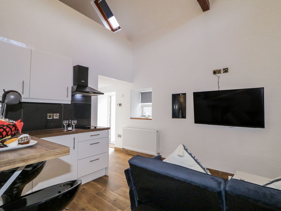 A living room with kitchen appliances and a sofa at Derrywilligan 1,2,3 in Newry