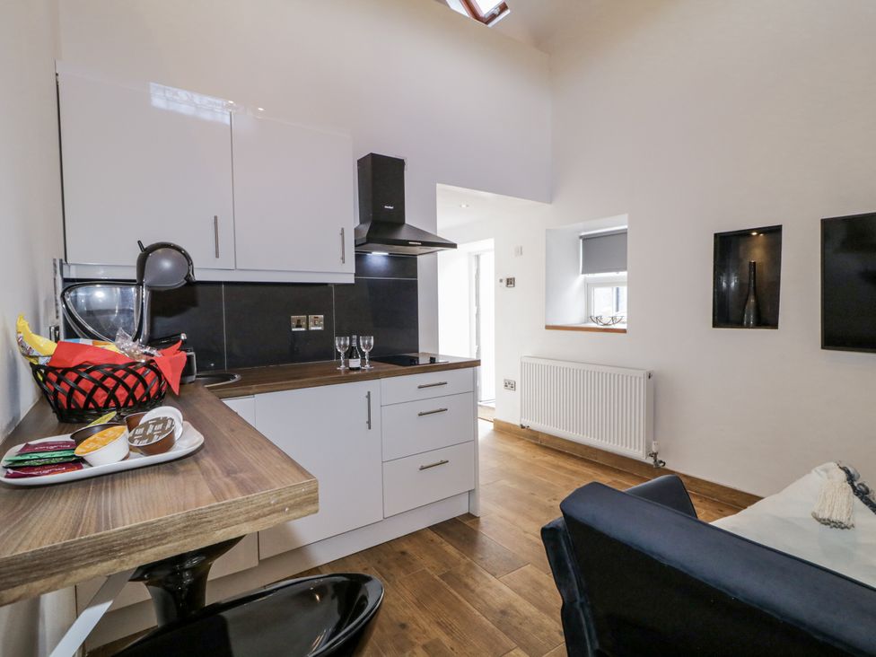A kitchen with units and a dining area at Derrywilligan 1,2,3 in Newry