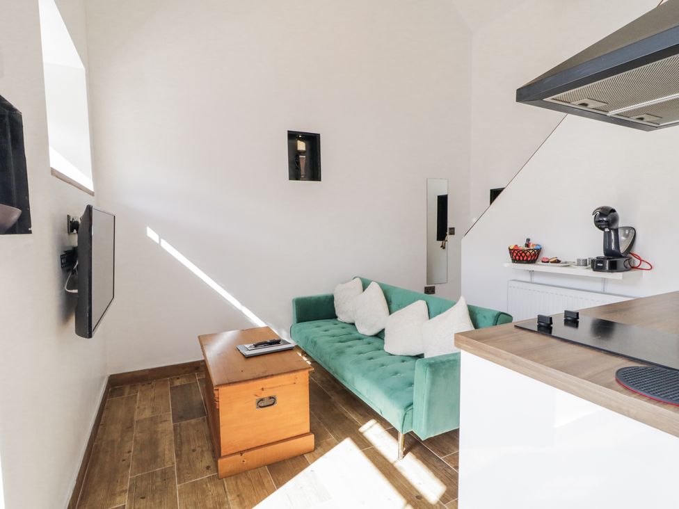 A living room with a sofa and television at Derrywilligan 1,2,3 Newry