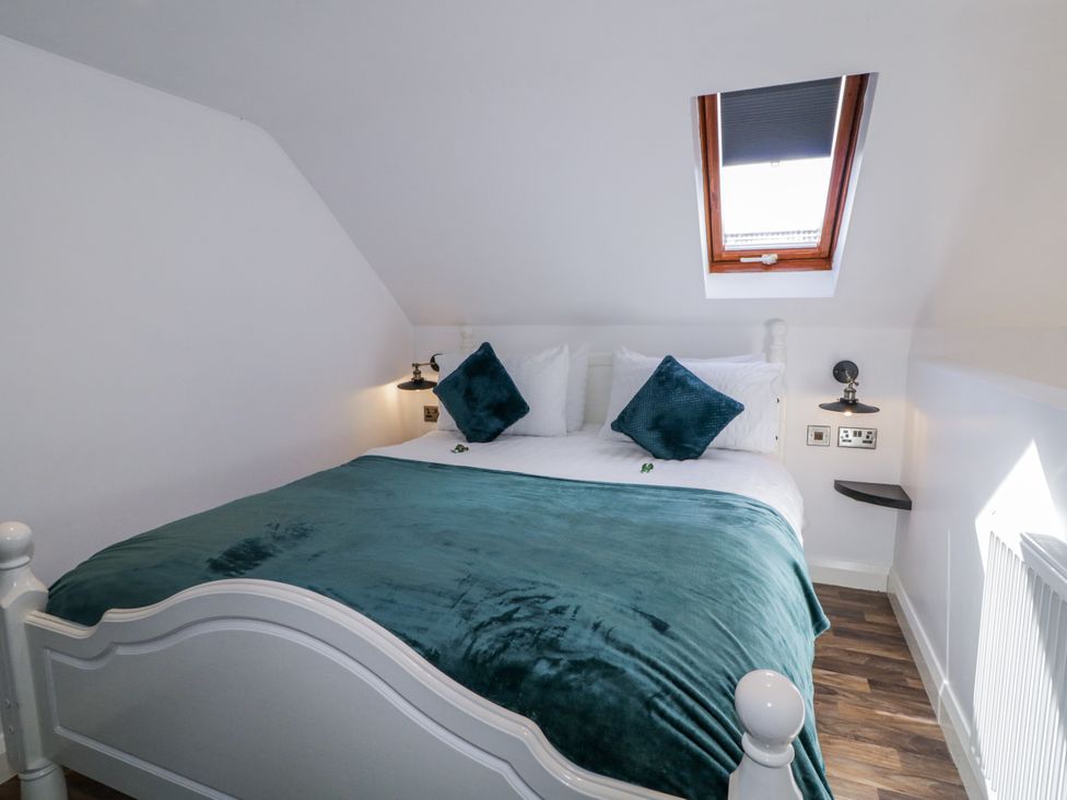 A bedroom with a bed and window at Derrywilligan 1,2,3 Newry