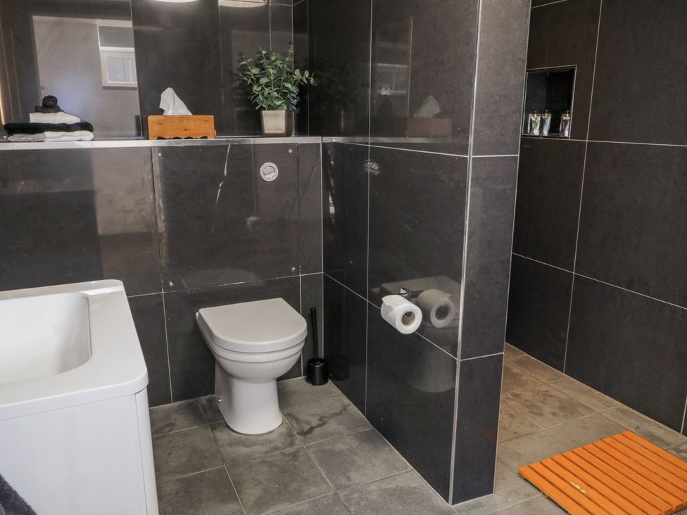 A bathroom with a toilet and bathtub at Derrywilligan 1,2,3 Newry