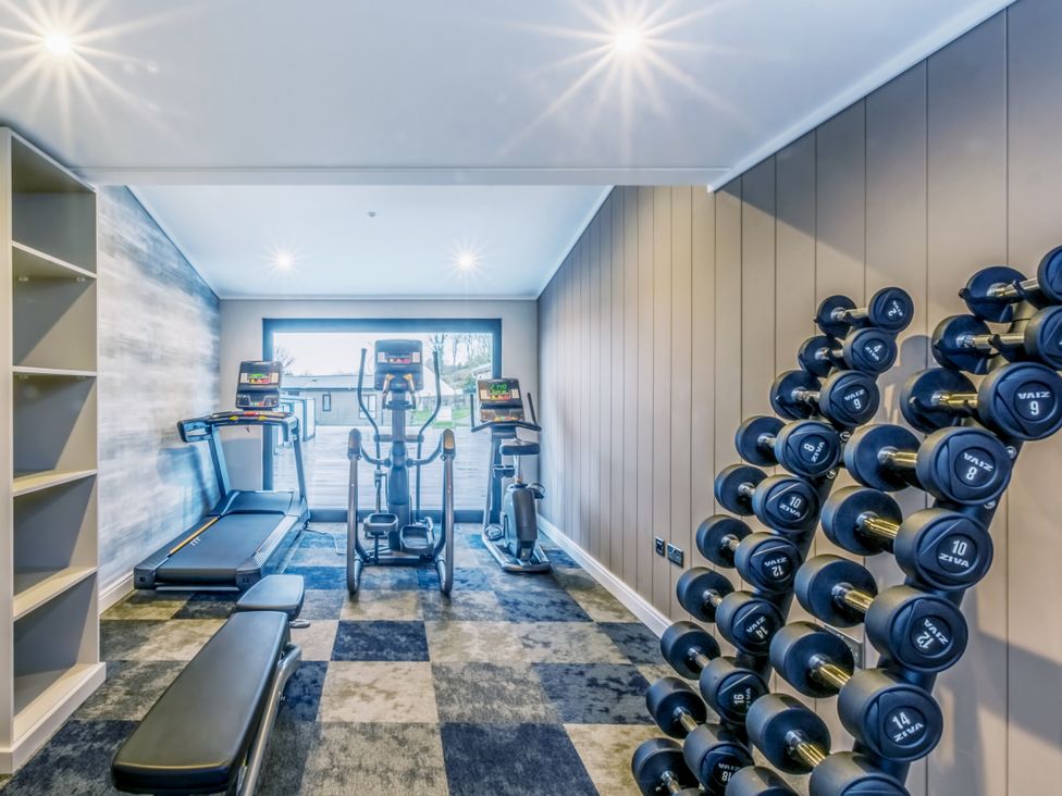 A gym with exercise equipment at Chalet 2 at Landscove Holiday Park Brixham