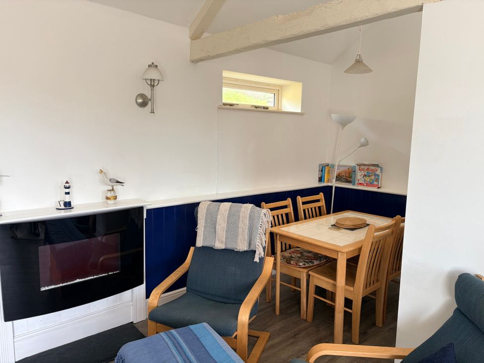 A dining area with chairs and a table at Lighthouse Cottage St Erme near Truro