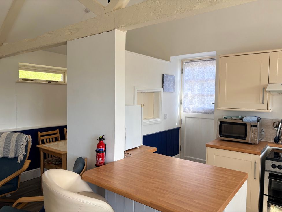 A kitchen with a microwave and kitchen counter at Lighthouse Cottage St Erme near Truro