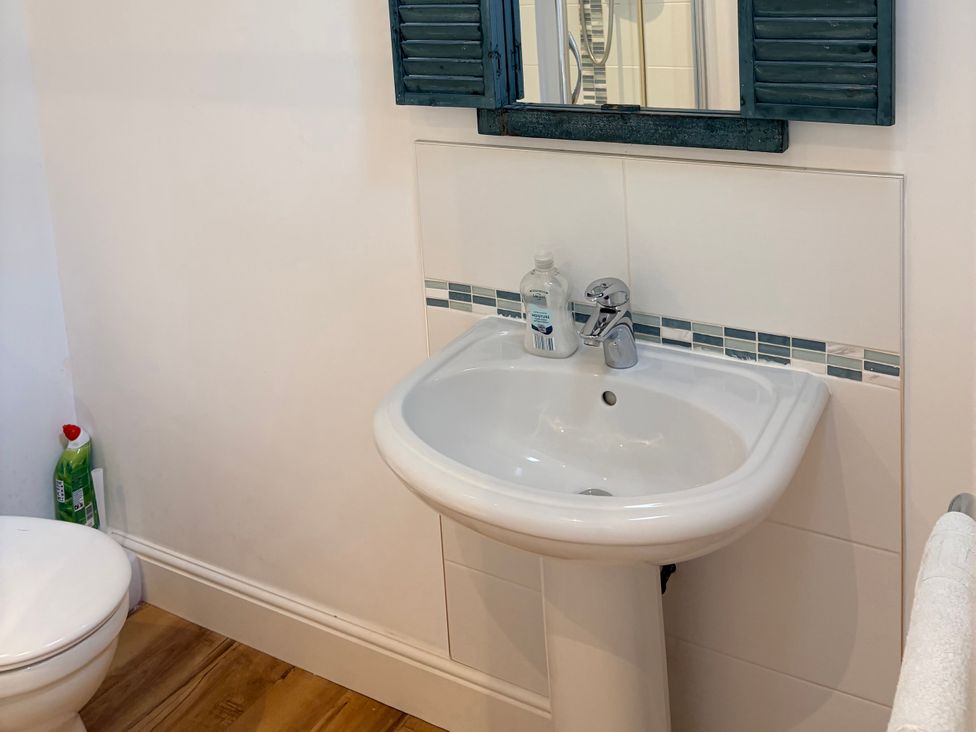 A bathroom with a sink and toilet at Lighthouse Cottage St Erme near Truro