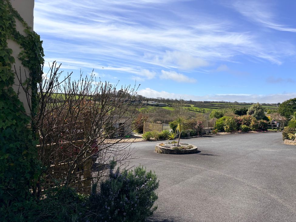 An outdoor area with garden and path at Lighthouse Cottage St Erme near Truro