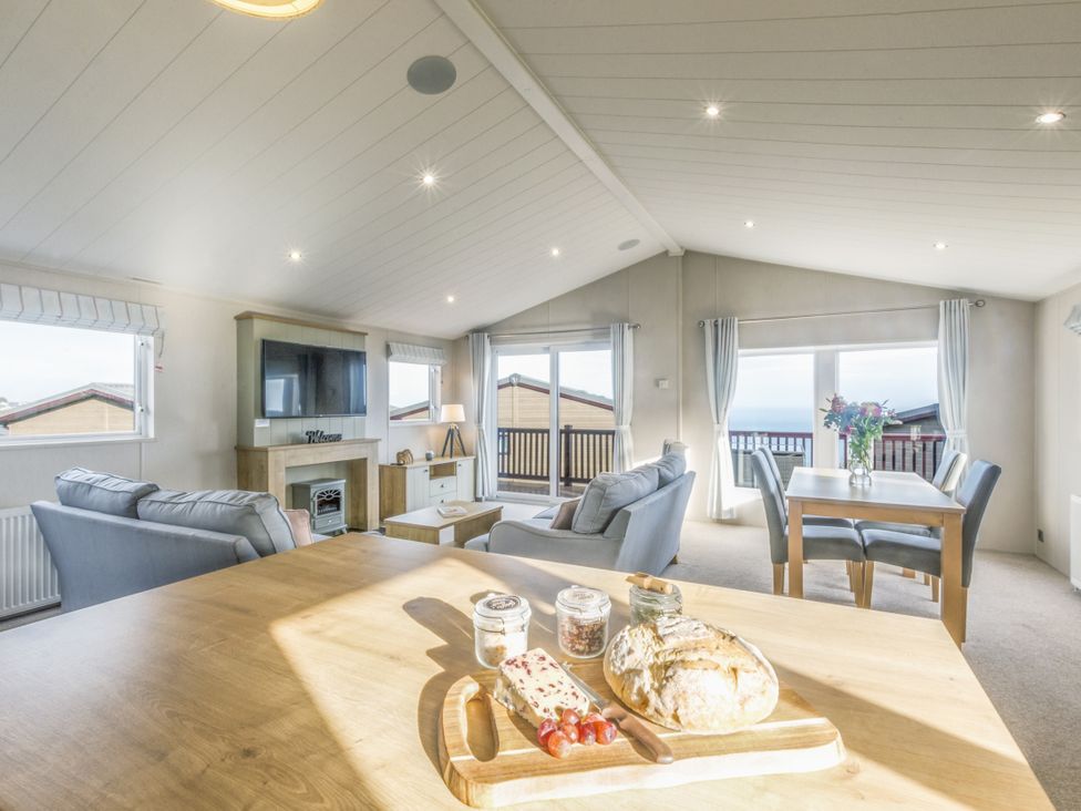 A living room with a sofa and a dining table at Lodge 58 at Riviera Bay Coastal Retreat Brixham