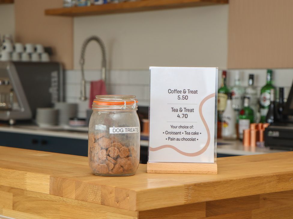 A cafe counter with dog treats and a menu at Lodge 62 at Riviera Bay Coastal Retreat Brixham