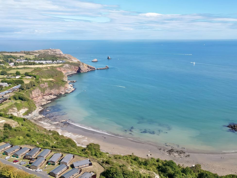 A coastal view with beach and cliffs at Lodge 62 at Riviera Bay Coastal Retreat Brixham