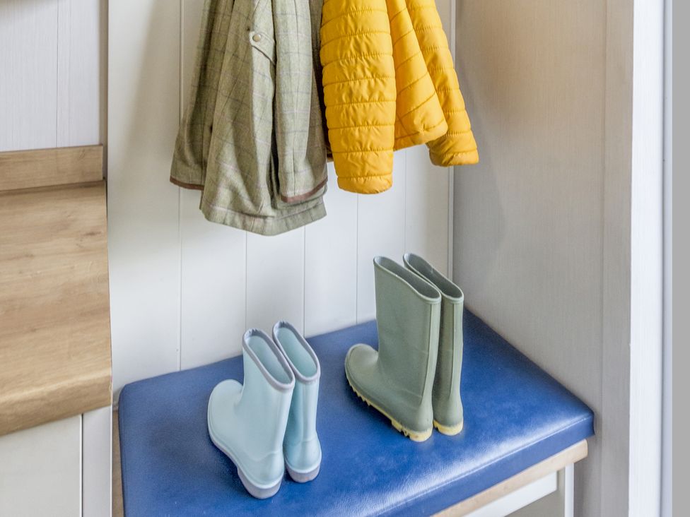 A bench with boots and jackets in the entrance at Lodge 62 at Riviera Bay Coastal Retreat Brixham