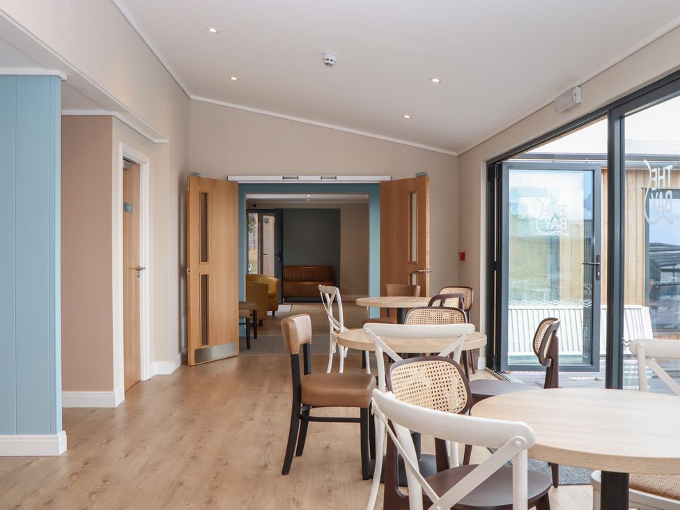 A dining area with tables and chairs at Lodge 69 at Riviera Bay Coastal Retreat, Brixham
