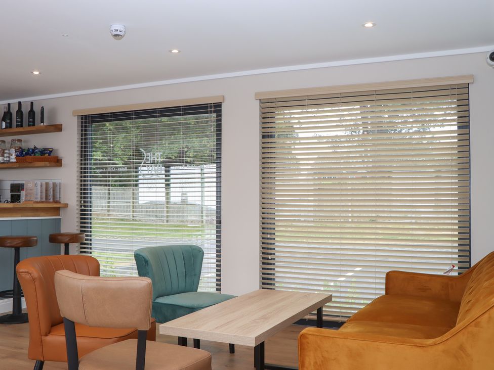 A snug with a dining table and bar stools at Lodge 69 at Riviera Bay Coastal Retreat Brixham