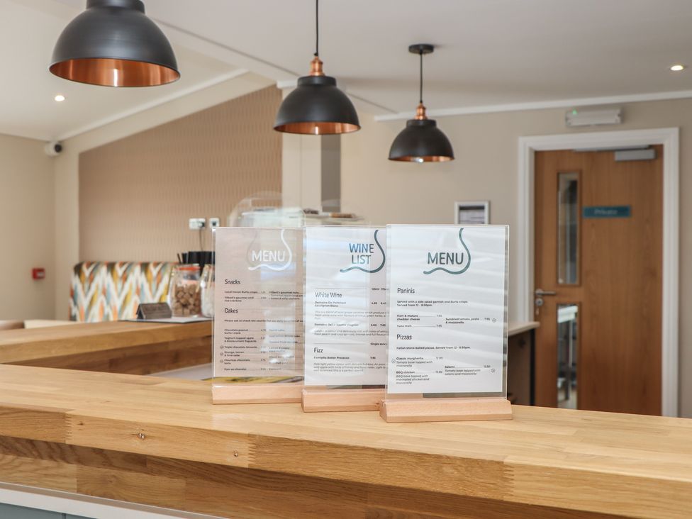 A menu display on a counter at Lodge 69 at Riviera Bay Coastal Retreat Brixham