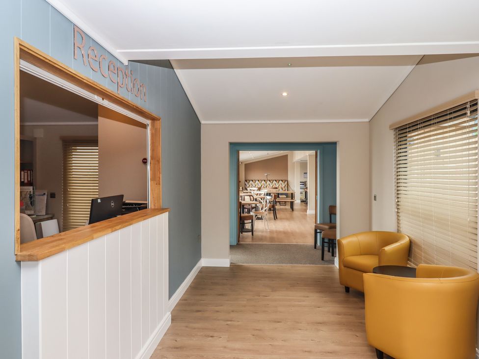A reception area with a desk and chairs at Lodge 69 at Riviera Bay Coastal Retreat Brixham