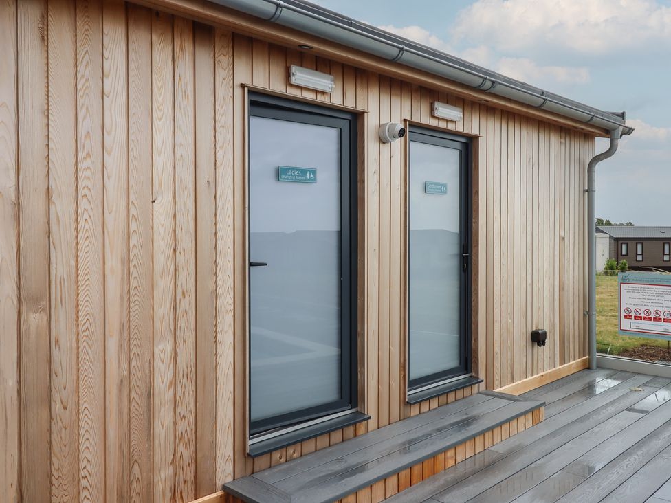 Two doors with signs in outdoor setting at Lodge 69 at Riviera Bay Coastal Retreat Brixham